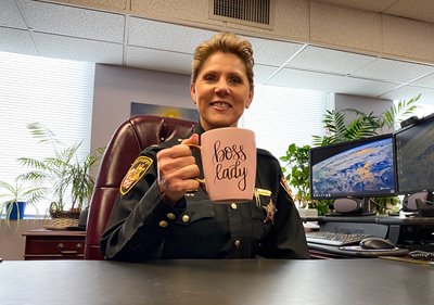 Sheriff Kandy Fatheree of Summit County holds a coffee mug that says "boss lady."